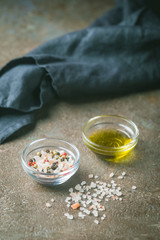 Seasonings for cooking. Sea salt and olive oil on a table