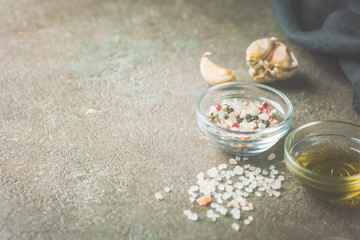 Seasonings for cooking. Sea salt and olive oil on a table