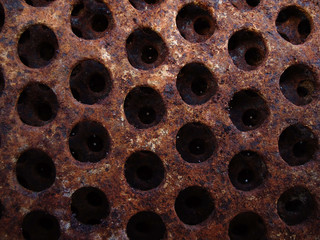 texture of rusty metal plate with holes