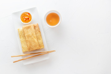 Traditional snacks of Chinese cuisine Dim Sum - tortillas - bings in a plate on a white background. View from above. Copy space