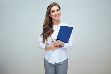 smiling nurse wearing medical uniform holding clipboard.