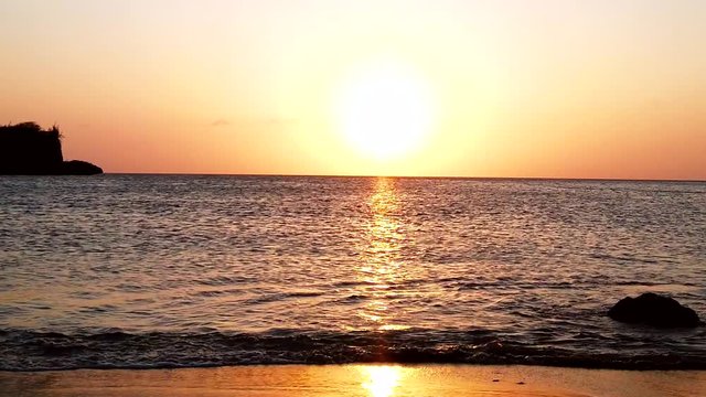 Beautiful sunset view on the shore of Santa cruse  beach with a golden color reflection on the beach waves