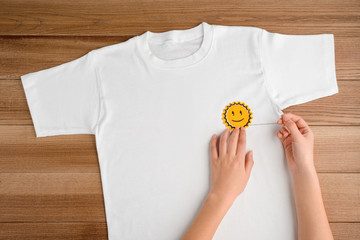 Girl sewing a smiling sun