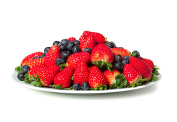 Three kinds of fresh berries on a white plate