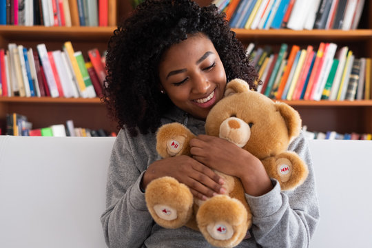 Young Black Woman Hugging A Teddy Bear