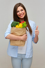 isolated studio portrait of smiling vegetarian girl show thumb up.