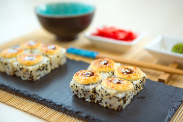 Fried sushi roll with shrimp and caviar. Fried hot Roll with salmon, avocado, cucumber.