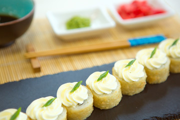 Assortment of delicious fresh, tempura and baked sushi maki with salmon, cucumber, avocado, scrambled eggs, shrimp and unagi sauce