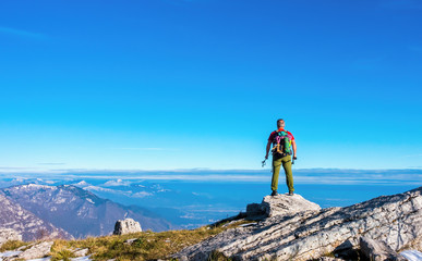 Hiker on the top in mountains. Travel sport lifestyle concept
