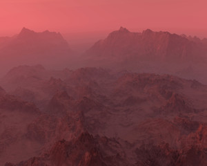 Rough mountains in mist at sunrise.