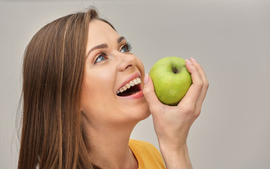 close up portrait of smiling woman with healthy teeth holding green apple.