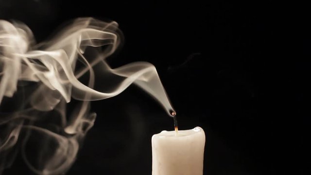 Candle blow out with smoke isolated on black background