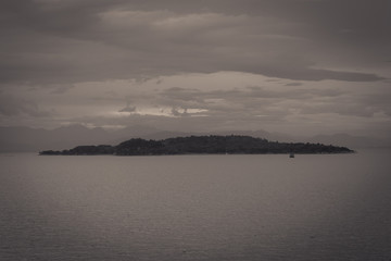 Vintage panorama of the island of Vidos near Corfu on a rainy day