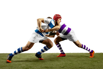 Plakat The silhouette of two caucasian rugby male players isolated on white background. Studio shot of fit men in motion or movement with ball. Jump and action concept. An incredible strain of all forces.