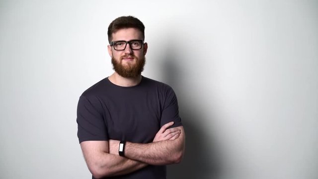 Half length portrait of young bearded hipster man smiling at camera