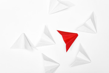 Stand out concept. Red paper airplane standing out from whites