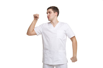 Young medical professional in workwear is dancing isolated on white background.