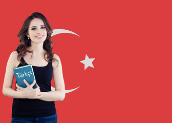 Cheerful young woman student with the Turkey flag. Learn turkish language, language school concept
