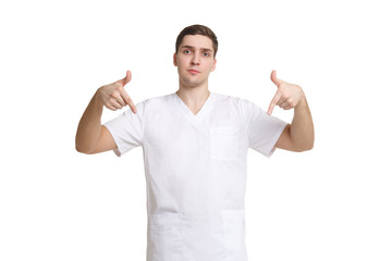 Young medical professional in overalls points fingers down isolated on white background.
