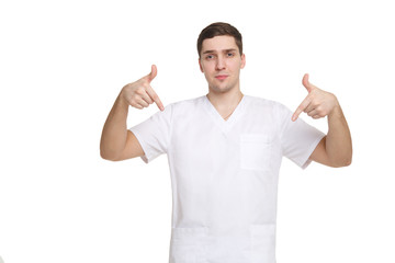 Young medical professional in overalls points fingers down isolated on white background.