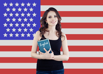 USA concept with pretty happy woman student portrait against the United States of America flag background. Travel and learn english language