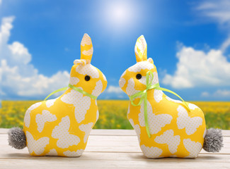 Two Easter yellow bunnies and empty space for text. Easter holiday concept.