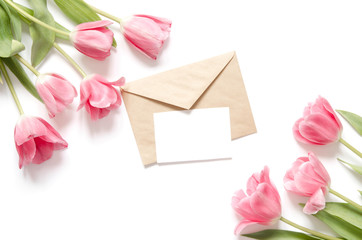 Floral background with tulips flowers and kraft envelope. Flat lay, top view. Lovely greeting card with tulips for Mothers day, wedding or happy event - Image.