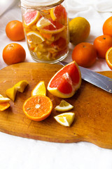lemons, oranges, tangerines, grapefruit, cut into slices and folded into a jar