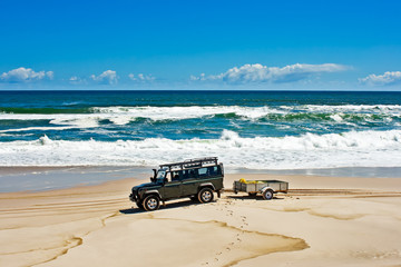 Green off-roader on beach © geoffsp