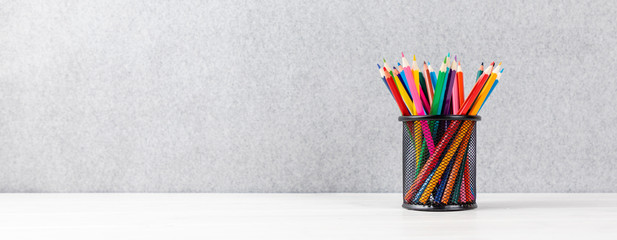 colorful pens in a quiver on a desk