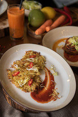 Healthy vegeterian food on brown wood board. Spring vitamin dieting food. Potato vegan pancakes with juice fruit and vegetables