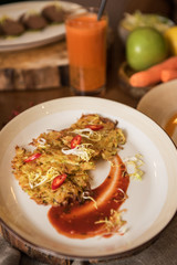 Healthy vegeterian food on brown wood board. Spring vitamin dieting food. Potato vegan pancakes with juice fruit and vegetables