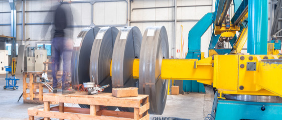 Moving Steel Cutting Machine, long exposure. Industrial machine for metel sheet coils cut, business...