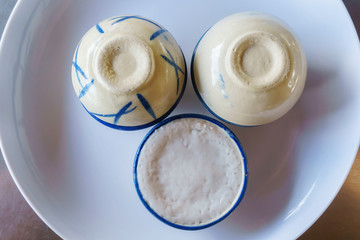 Traditional thai desert of coconut milk custard in small porcelain cup