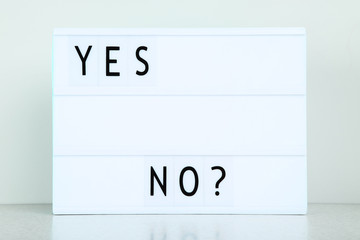 Lightbox with words Yes No on grey background