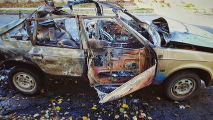 The blown-up car as a result of terrorist attack.