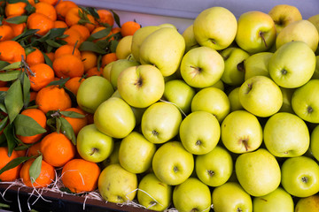 Apples and tangerines in greengrocery
