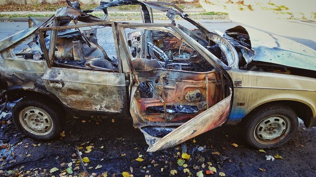 The blown-up car as a result of terrorist attack.