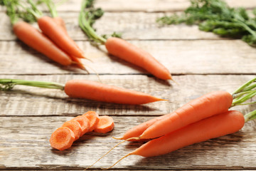 Fresh carrot on grey wooden table