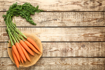 Fresh and sweet carrot on wooden background