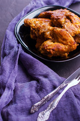 Spicy Deep Fried Breaded Chicken Wings on dark stone background.