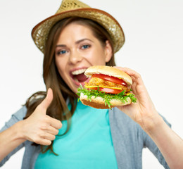 girl holding big burger in front of face.