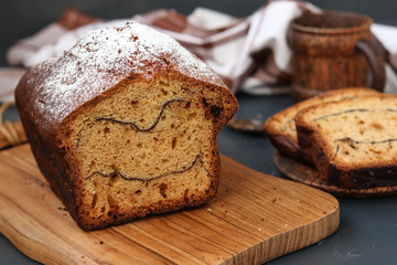 Cake with cocoa located on a dark background, On the cut of the cake strips of cocoa