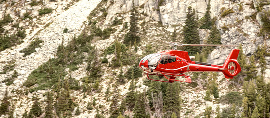 Red rescue helicopter in a mountain operation © jovannig