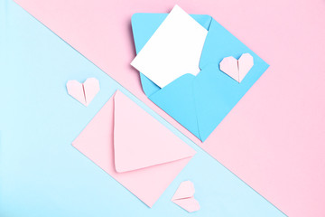 Paper envelopes and hearts on colorful background