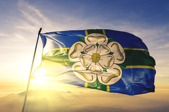 North Yorkshire North Riding county flag waving on the top sunrise mist fog