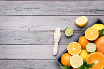 Citrus fruits in tray on wooden table
