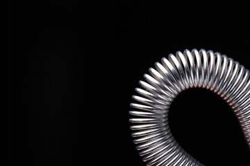 Metal spring on black