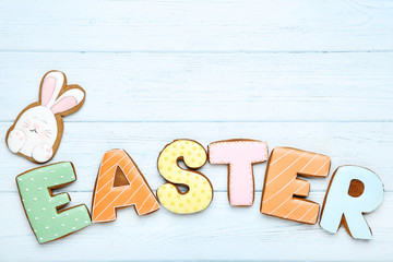 Word Easter by gingerbread cookies on wooden table