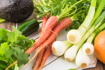 Ingredients for roasted pork chops and vegetables with  orange avocado salsa